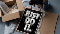 Just Do It typography design framed print being unpacked from protective bubble wrap and a box