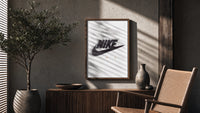 Blurred Nike swoosh logo poster framed above a fluted sideboard beside an olive tree