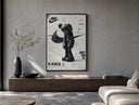 KAWS Companion figure standing poster framed above a wood console in a concrete-wall living room