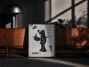 Black-framed KAWS Companion figure standing print on a moody console with designer coffee-table books