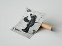 Rolled KAWS Companion figure standing poster beside its crush-resistant kraft shipping tube