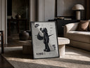 KAWS Companion figure standing print in a black frame leaning on a travertine table in a sunlit lounge