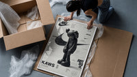 KAWS Companion figure standing framed print being unpacked from protective bubble wrap and a box