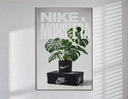 Monstera plant in Nike pot poster in a slim frame on a bright wall with soft window light