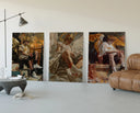 winged crowned angel youths seated three-panel set displayed beside a brown leather sofa