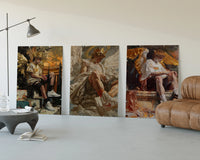 winged crowned angel youths seated three-panel set displayed beside a brown leather sofa