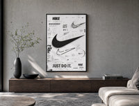 Nike Swoosh logo design study poster framed above a wood console in a concrete-wall living room