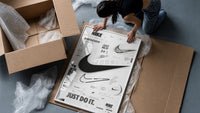 Nike Swoosh logo design study framed print being unpacked from protective bubble wrap and a box