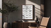 Various hand-drawn Nike swoosh logos poster framed above a fluted sideboard beside an olive tree