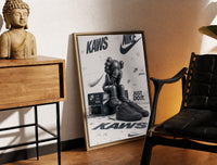 Brass-framed KAWS Companion figure and sneaker print leaning in a warm styled corner by a sculpture