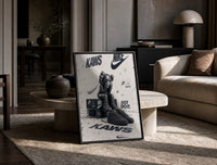 KAWS Companion figure and sneaker print in a black frame leaning on a travertine table in a sunlit lounge