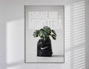 Monstera plant in Nike garbage bag poster in a slim frame on a bright wall with soft window light