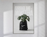 Monstera plant in Nike garbage bag poster in a slim frame on a bright wall with soft window light