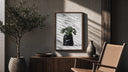 Monstera plant in Nike garbage bag poster framed above a fluted sideboard beside an olive tree
