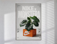 Monstera plant in Nike shoe box poster in a slim frame on a bright wall with soft window light