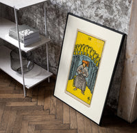 Seated man before nine golden cups poster in a black frame leaning beside a shelf in a raw-plaster loft