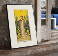 Woman with falcon in vineyard print in a black frame leaning beside a vintage door on parquet