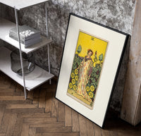 Woman with falcon in vineyard poster in a black frame leaning beside a shelf in a raw-plaster loft