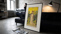 Woman with falcon in vineyard print in a slim black frame leaning on a dark sofa in a concrete print studio