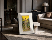 Woman with falcon in vineyard print in a black frame leaning on a travertine table in a sunlit lounge