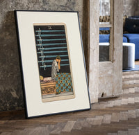 Person seated with nine swords print in a black frame leaning beside a vintage door on parquet