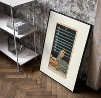 Person seated with nine swords poster in a black frame leaning beside a shelf in a raw-plaster loft
