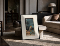 Person seated with nine swords print in a black frame leaning on a travertine table in a sunlit lounge