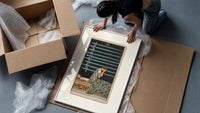 Person seated with nine swords framed print being unpacked from protective bubble wrap and a box