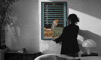 Nine of Swords print in a slim black frame being hung on a sunlit wall in a monochrome room