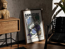 Walnut-framed Purple GameCube console with controller print leaning against a sunlit rustic brick wall