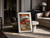 French coastal travel scenes print in a black frame leaning on a travertine table in a sunlit lounge