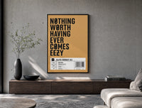 Motivational typography shoe box label poster framed above a wood console in a concrete-wall living room