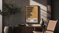 Motivational typography shoe box label poster framed above a fluted sideboard beside an olive tree