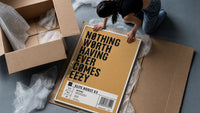 Motivational typography shoe box label framed print being unpacked from protective bubble wrap and a box