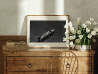 advertising blimp airship print in an oak frame on a farmhouse dresser beside white tulips