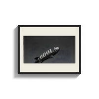 Framed advertising blimp airship print shown as a wide statement piece on a clean white wall