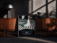 Black-framed White Nike Air Force 1 sneaker print on a moody console with designer coffee-table books
