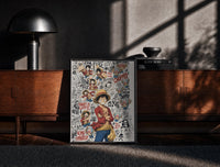 Black-framed Monkey D. Luffy and Chopper collage print on a moody console with designer coffee-table books
