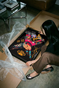 Person unrolling the Tony Chopper 3D2Y cyberpunk anime print on a concrete floor