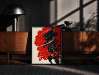 Black-framed Demon-masked samurai riding black horse print on a moody console with designer coffee-table books