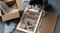 Orient Express railway travel poster framed print being unpacked from protective bubble wrap and a box