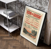 French Auvergne railway travel advertisement poster in a black frame leaning beside a shelf in a raw-plaster loft