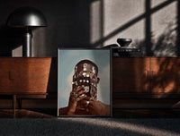 Black-framed Ornate Headpiece with Fringe and Rings print on the floor in front of a dark wooden console