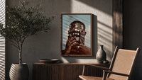Ornate Headpiece with Fringe and Rings poster framed above a fluted sideboard beside a potted tree