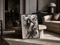 Long-haired man with giant white snake print in a black frame leaning on a travertine table in a sunlit lounge