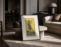 Youth holding pentacle coin print in a black frame leaning on a travertine table in a sunlit lounge