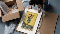 Youth holding pentacle coin framed print being unpacked from protective bubble wrap and a box