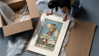 Young figure holding upraised sword framed print being unpacked from protective bubble wrap and a box