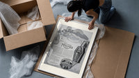 Reclining Egyptian woman perfume advertisement framed print being unpacked from protective bubble wrap and a box