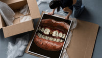 Parted Lips with Gold-Tone Grillz framed print being unpacked from protective bubble wrap and a box